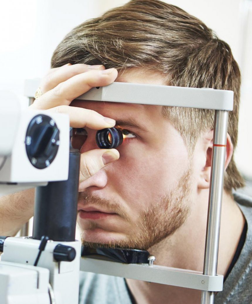 Ophthalmology concept. Male patient under eye vision examination in eyesight ophthalmological correction clinic