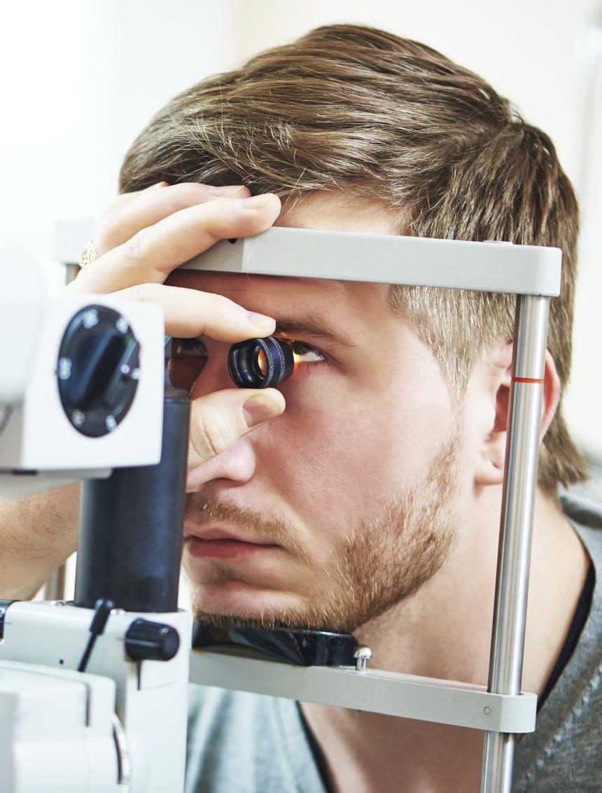 Ophthalmology concept. Male patient under eye vision examination in eyesight ophthalmological correction clinic