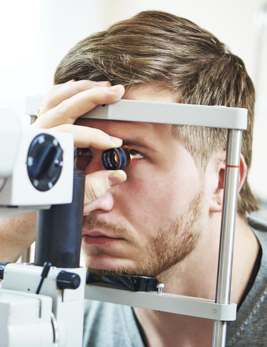 Ophthalmology concept. Male patient under eye vision examination in eyesight ophthalmological correction clinic